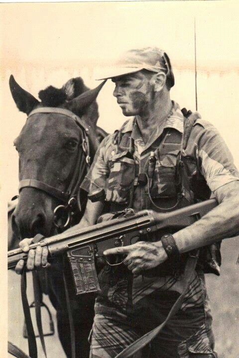 Black and white photo of a man, a horse and a G3